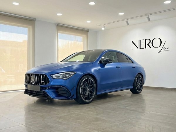 Mercedes-Benz CLA 45s AMG — Showroom view The matte blue Mercedes-Benz CLA 45s AMG is showcased from a front three-quarter angle in a modern showroom in Alicante.