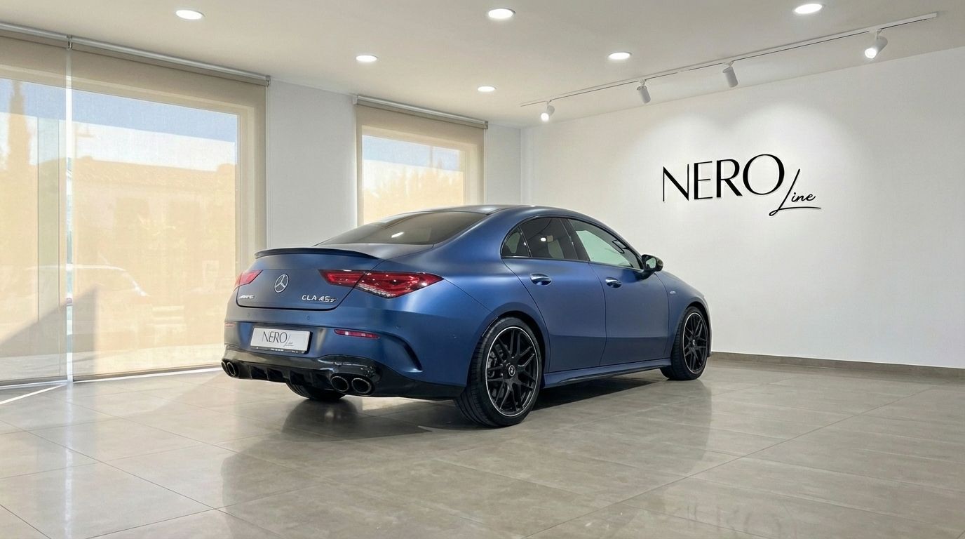 Matte blue Mercedes-Benz CLA 45s AMG from a rear three-quarter angle, parked indoors in Alicante with the Nero Line logo.