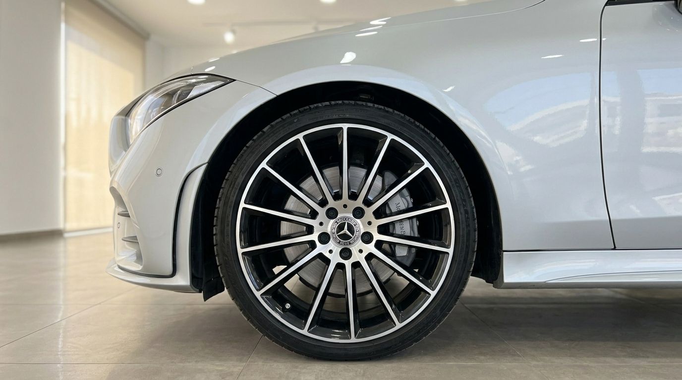 The Mercedes-Benz CLS 450 4MATIC's elegant front wheel, fender, and headlight are showcased in Alicante.