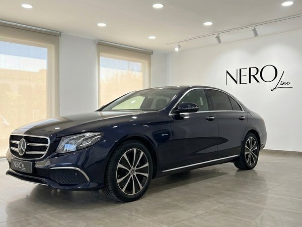 Mercedes-Benz E 300de EQ Power — Showroom Alicante The dark blue Mercedes-Benz E 300de EQ Power is parked at a slight angle in a showroom in Alicante, showing its front and side.