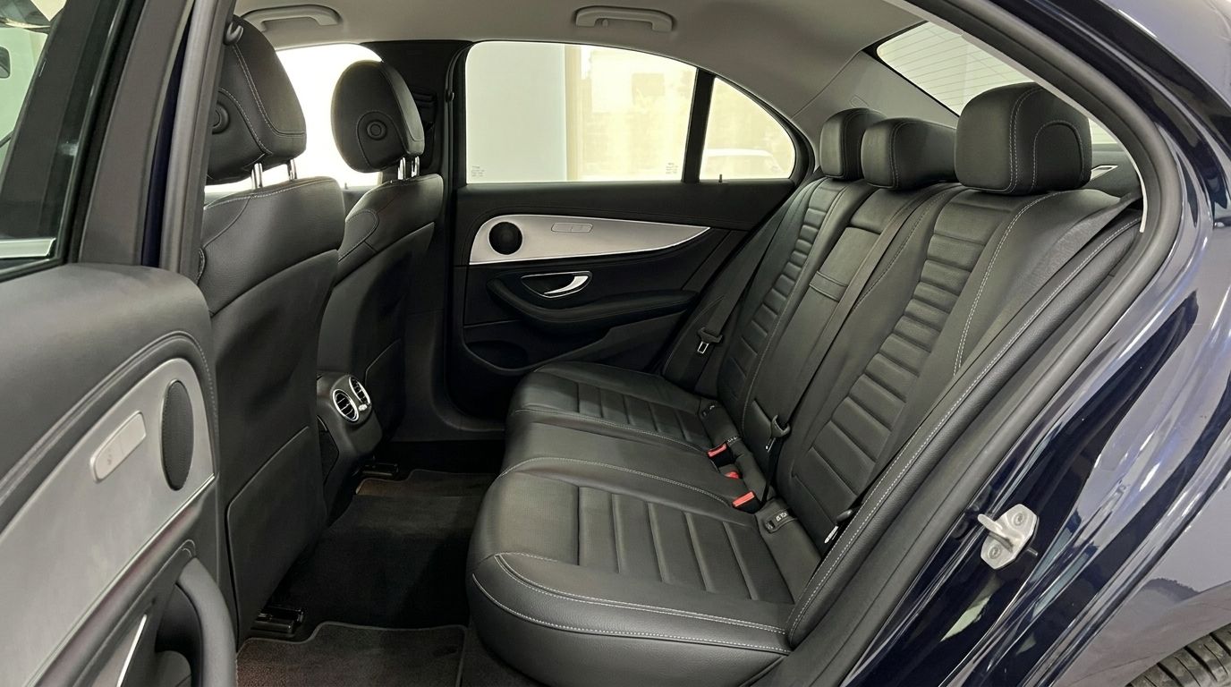 The luxurious black leather rear seats and door panel of the Mercedes-Benz E 300de EQ Power in Alicante.