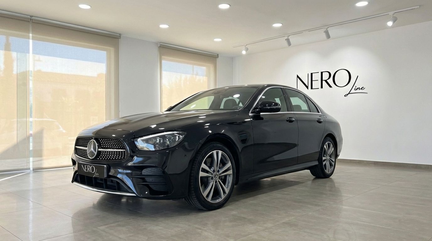 The black Mercedes-Benz E 300de luxury sedan is parked in a showroom in Barcelona, showcasing its elegant front three-quarter view.