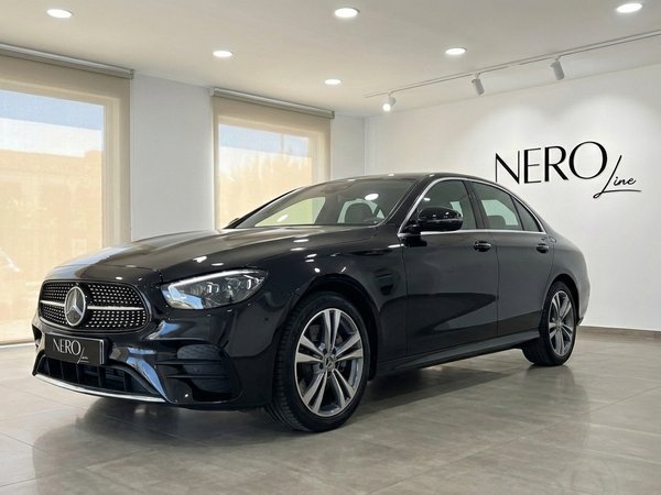 Mercedes-Benz E 300de — Luxury Sedan in Barcelona The black Mercedes-Benz E 300de luxury sedan is parked in a showroom in Barcelona, showcasing its elegant front three-quarter view.