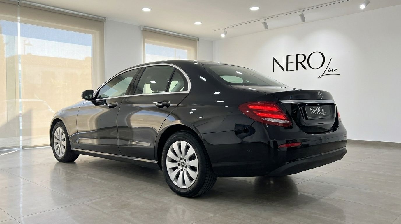 The black Mercedes-Benz E-Class sedan is parked indoors, shown from a rear three-quarter angle in Alicante.