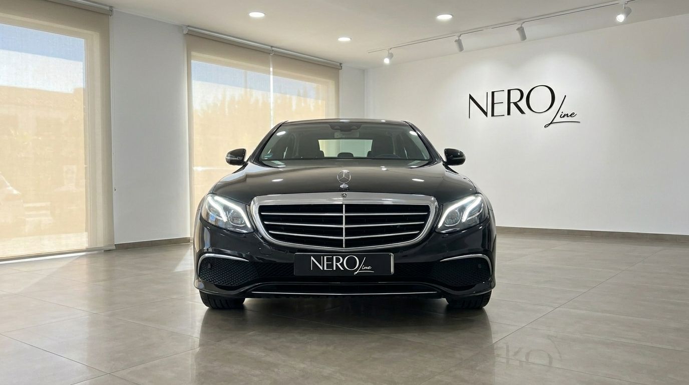 The black 2019 Mercedes-Benz E-Class sedan is shown from a direct front view in a luxury showroom in Alicante.