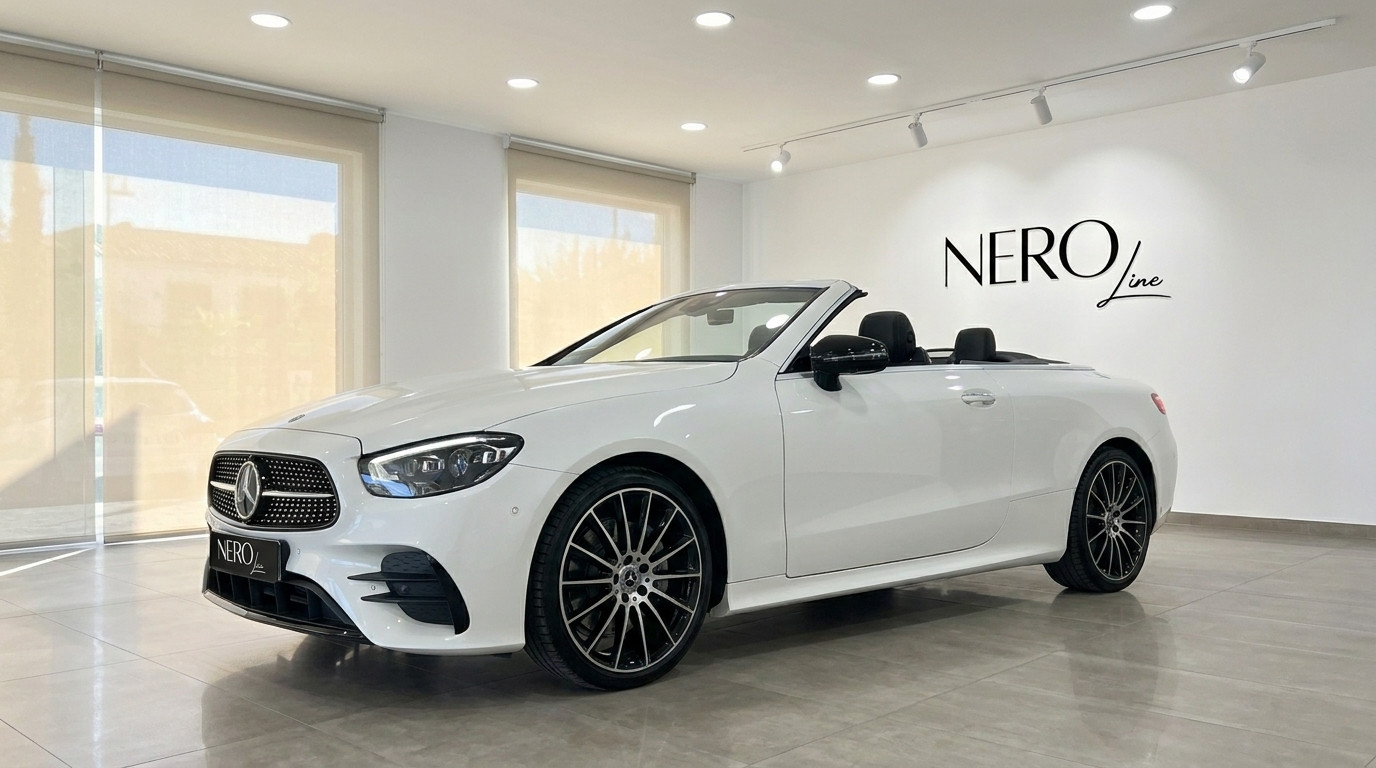 Mercedes-Benz E200 Cabrio — Cabriolet de luxe à Marbella La Mercedes-Benz E200 Cabrio blanche, un cabriolet de luxe, est présentée de trois quarts avant dans un showroom à Marbella.