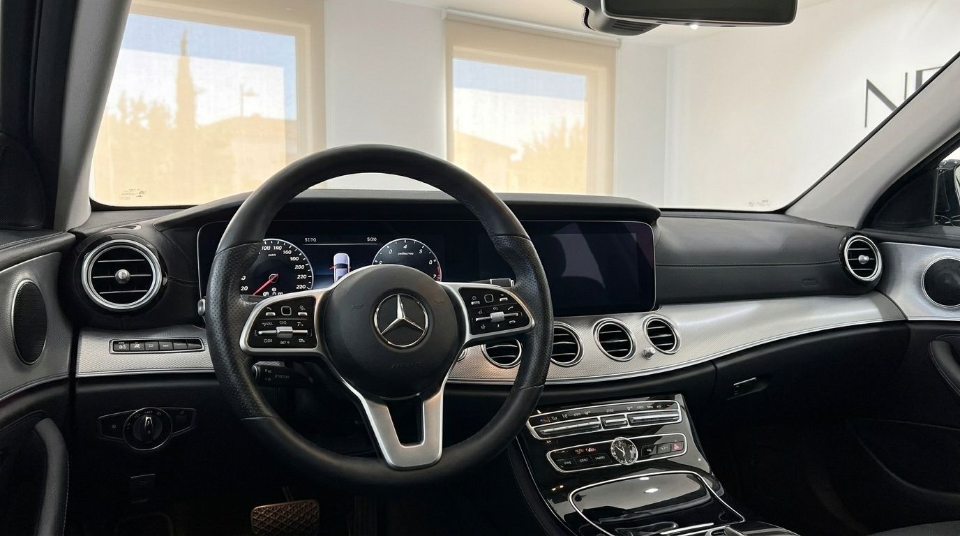 The luxurious interior of the Mercedes-Benz E 300de EQ Power, featuring the dashboard, steering wheel, and dual screens in Alicante.