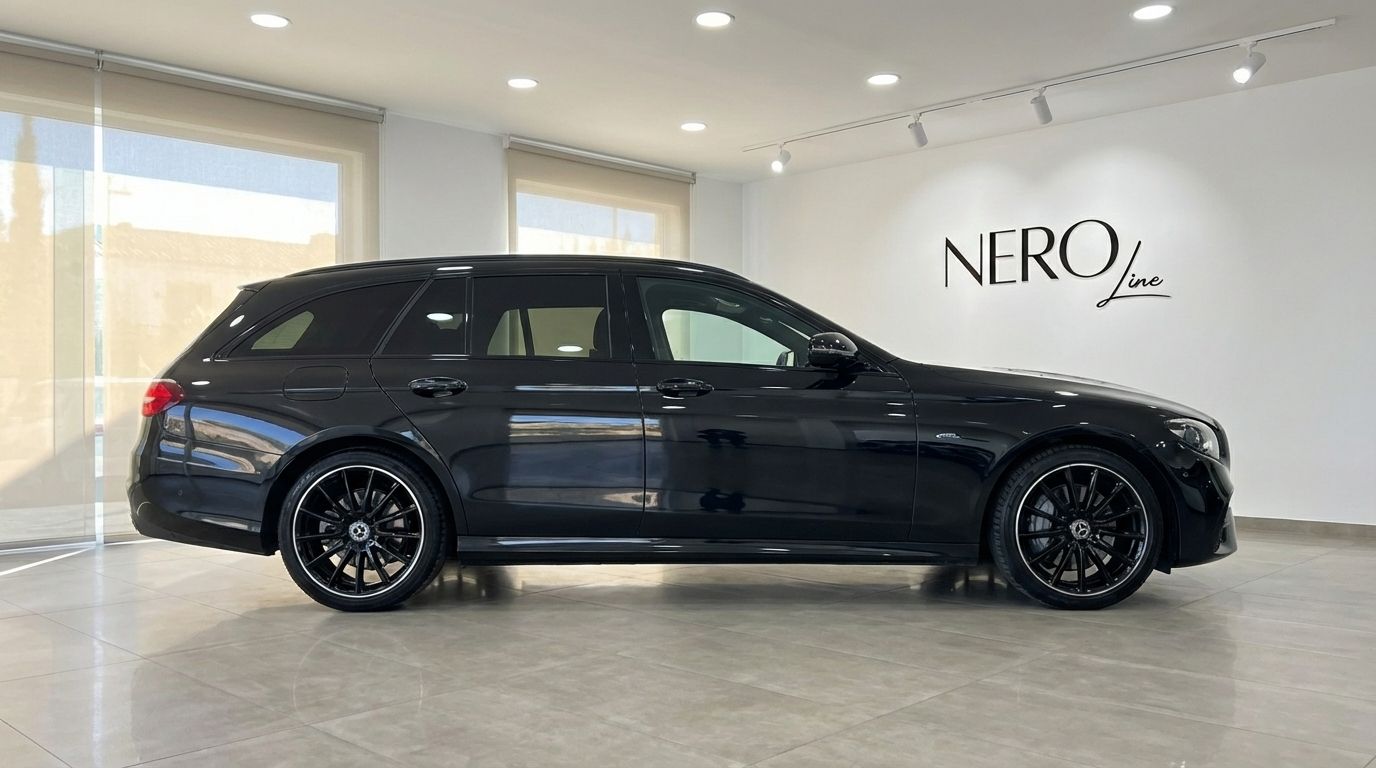 Black Mercedes-Benz E300e AMG line Estate, a plug-in hybrid, shown from the side in a showroom in Alicante.
