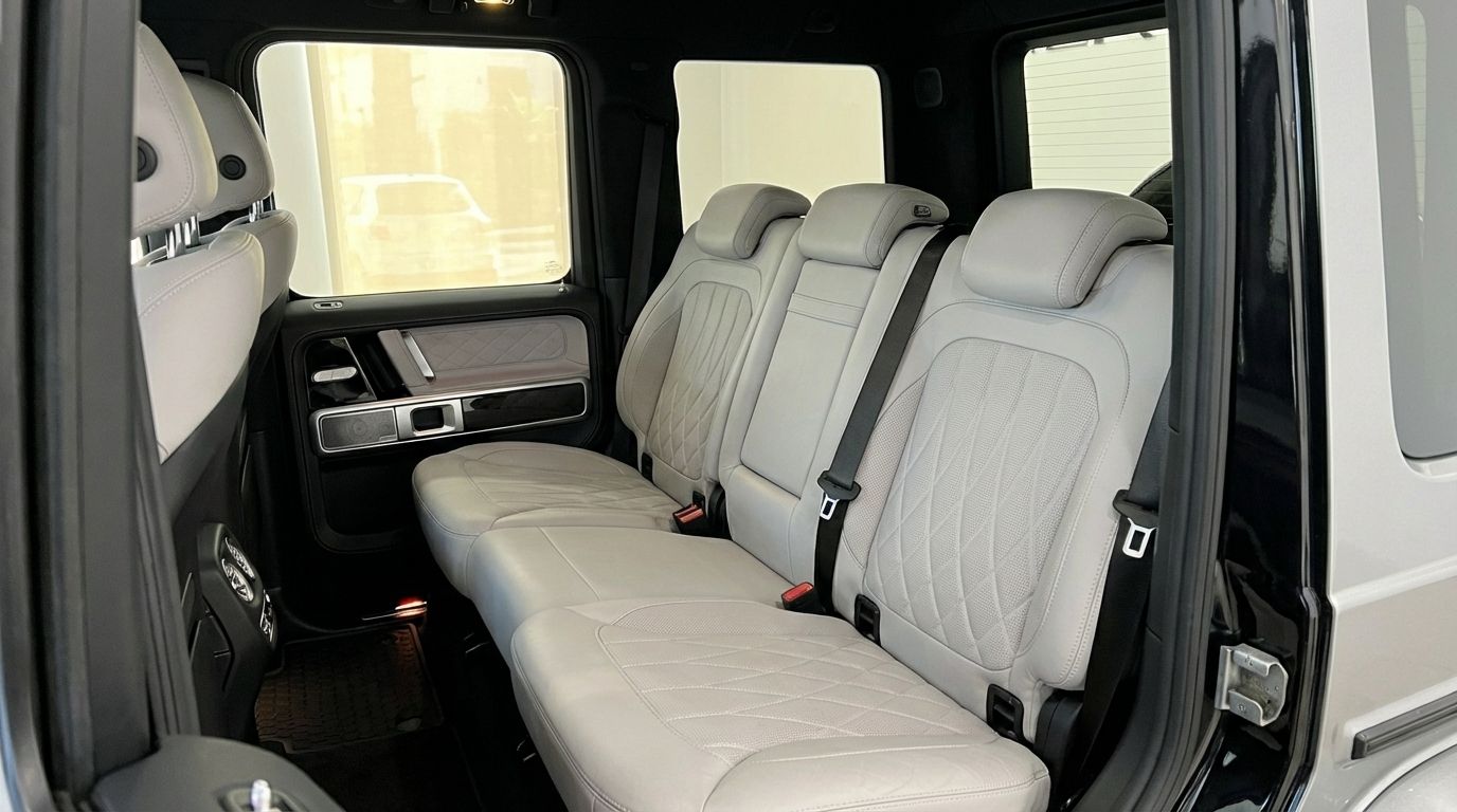 The luxurious light grey leather rear seats with diamond stitching inside the Mercedes-Benz G 500 available for rent in Marbella.