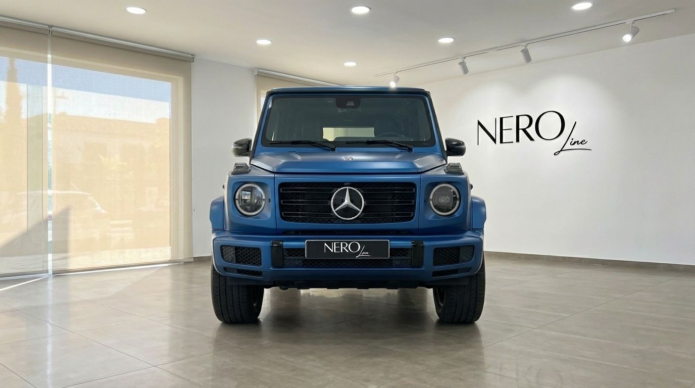 The matte dark blue 2025 Mercedes-Benz G 580 EQ is showcased from the front view in a bright showroom in Mallorca.