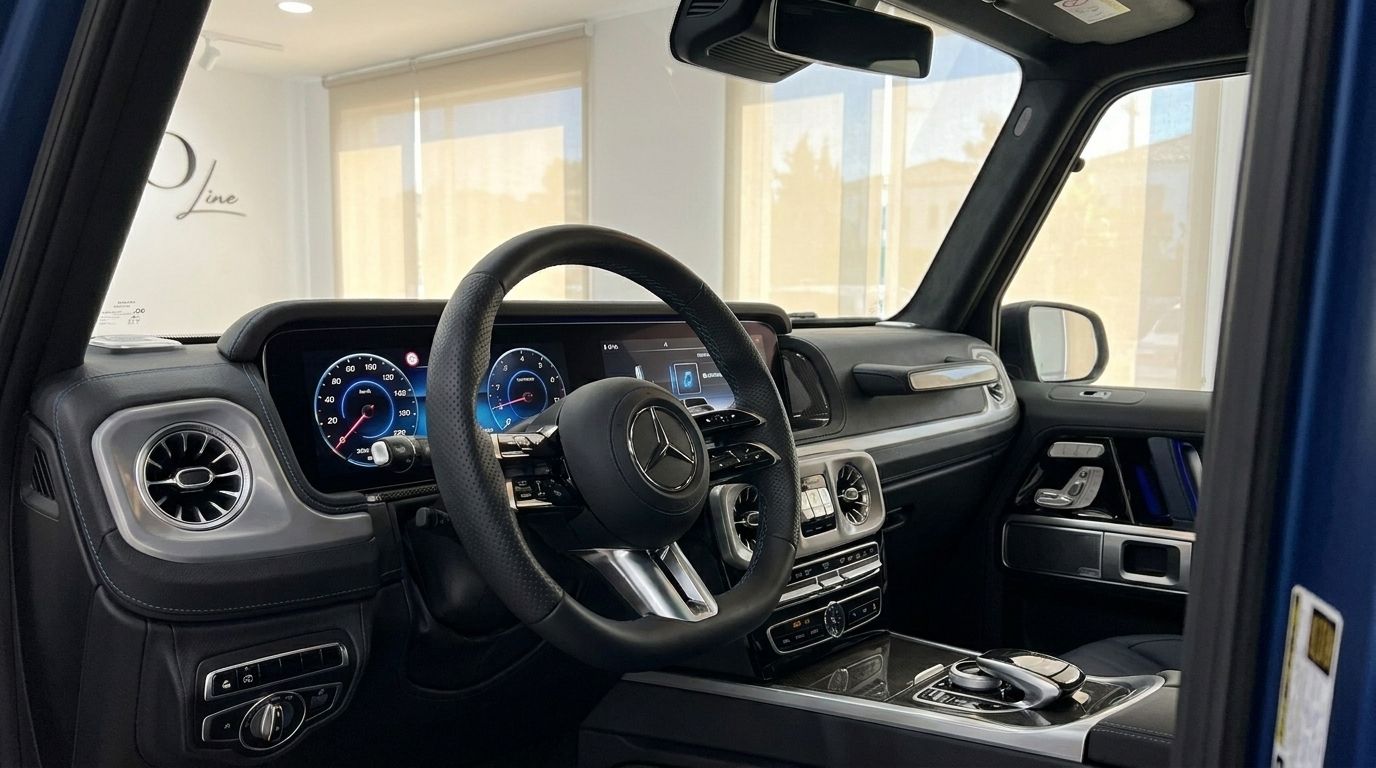 The luxurious cockpit of the Mercedes-Benz G 580 EQ in Mallorca, showcasing its steering wheel and digital dashboard.