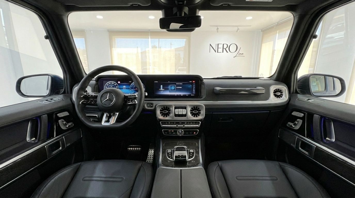 The luxurious interior of the 2025 Mercedes-Benz G 580 EQ, showcasing its modern dashboard, steering wheel, and black leather seats.