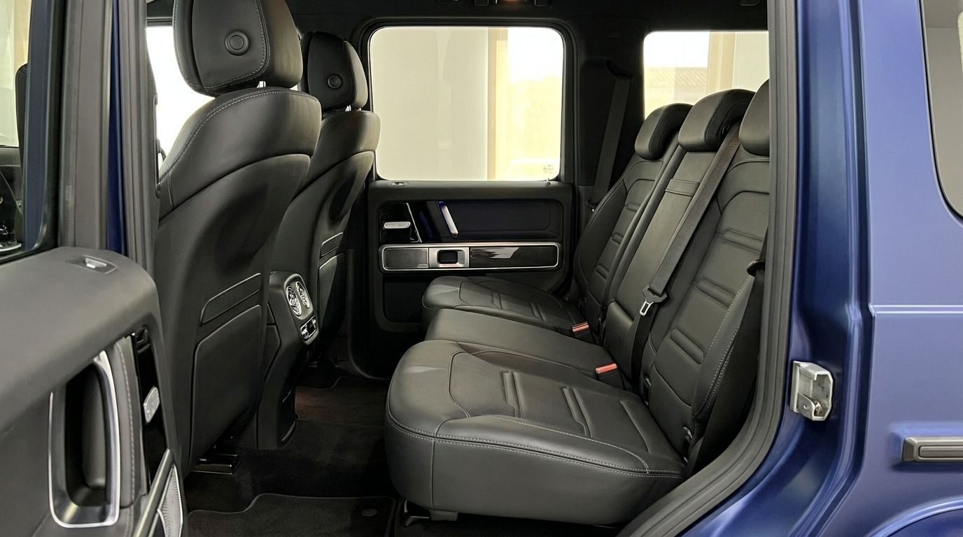 View of the luxurious black leather rear seats and door panel inside the Mercedes-Benz G 580 EQ in Mallorca.