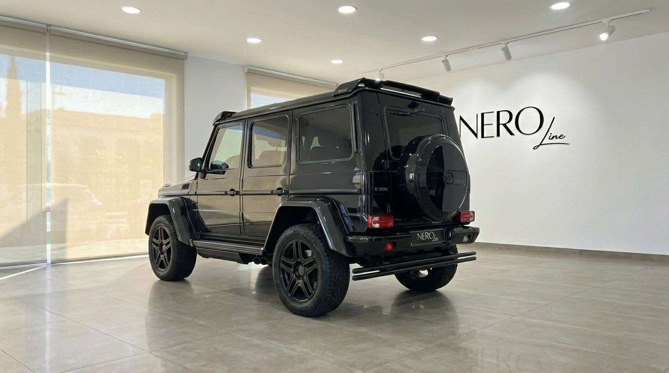 The black 2020 Mercedes-Benz G 500 luxury SUV is shown from a rear three-quarter view, parked in a bright showroom in Marbella.