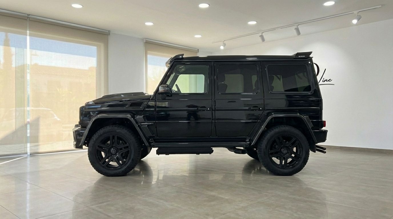 The black 2020 Mercedes-Benz G 500, customized with Brabus elements, is parked indoors, viewed from its side in Marbella.