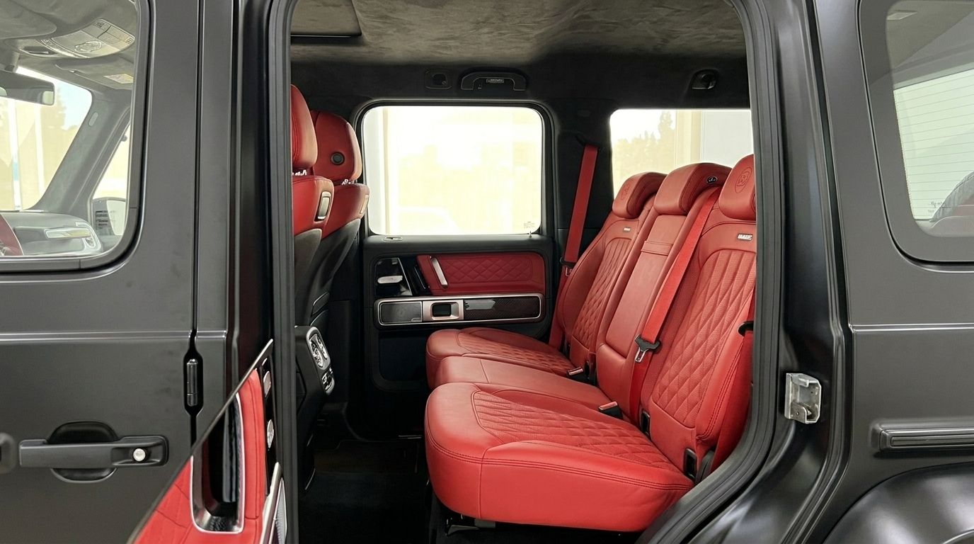 The luxurious red leather rear seats and matte black interior of the Mercedes-Benz G63 800 BRABUS are visible in Ibiza.