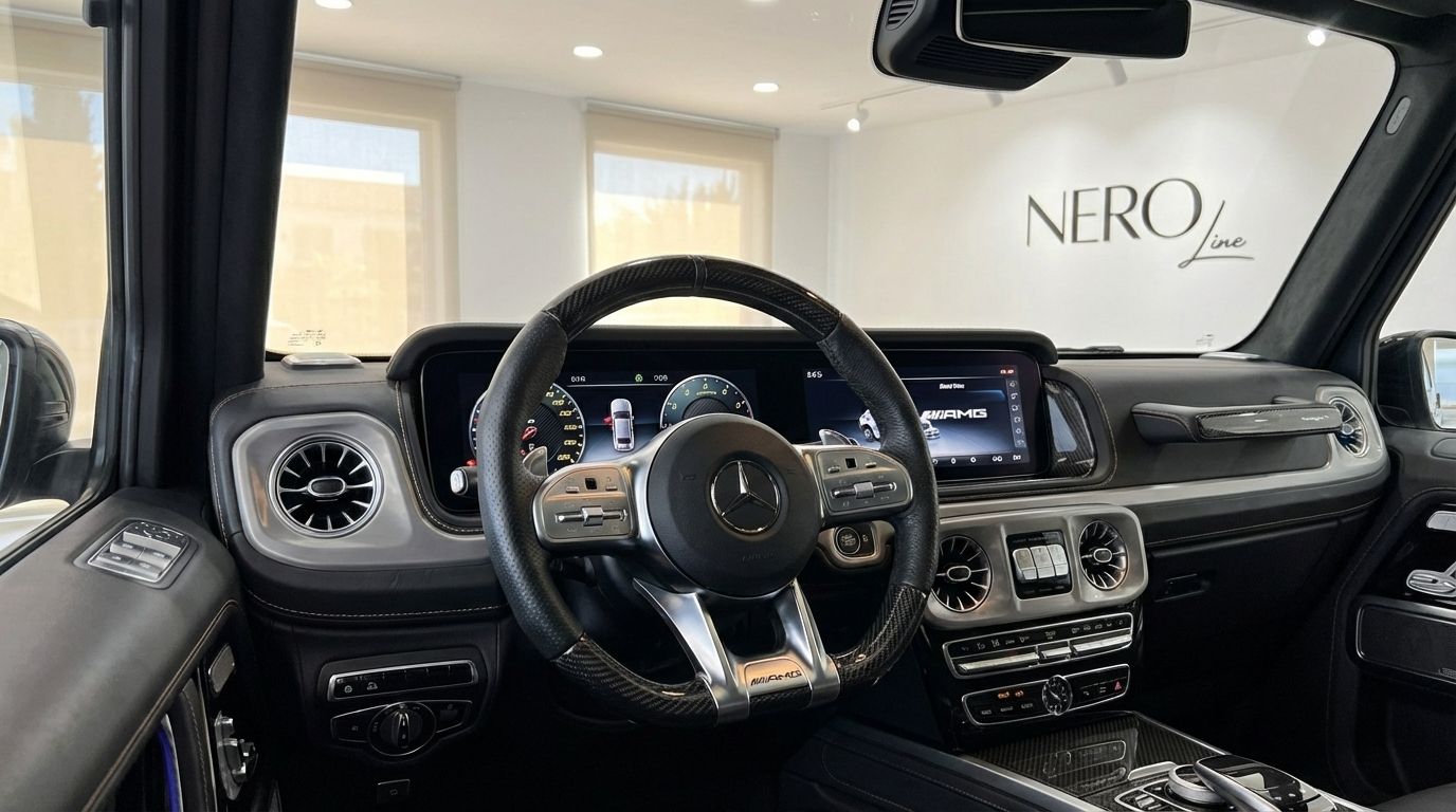 The luxurious cockpit and dashboard of the 2022 Mercedes-Benz G63 AMG with a carbon fiber steering wheel, located in Alicante.