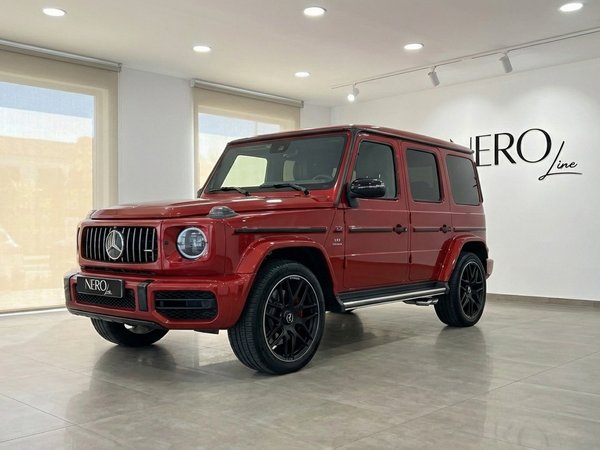 Mercedes-Benz G63 AMG — Showroom view Alicante The glossy red 2022 Mercedes-Benz G63 AMG performance SUV is showcased in a showroom in Alicante.