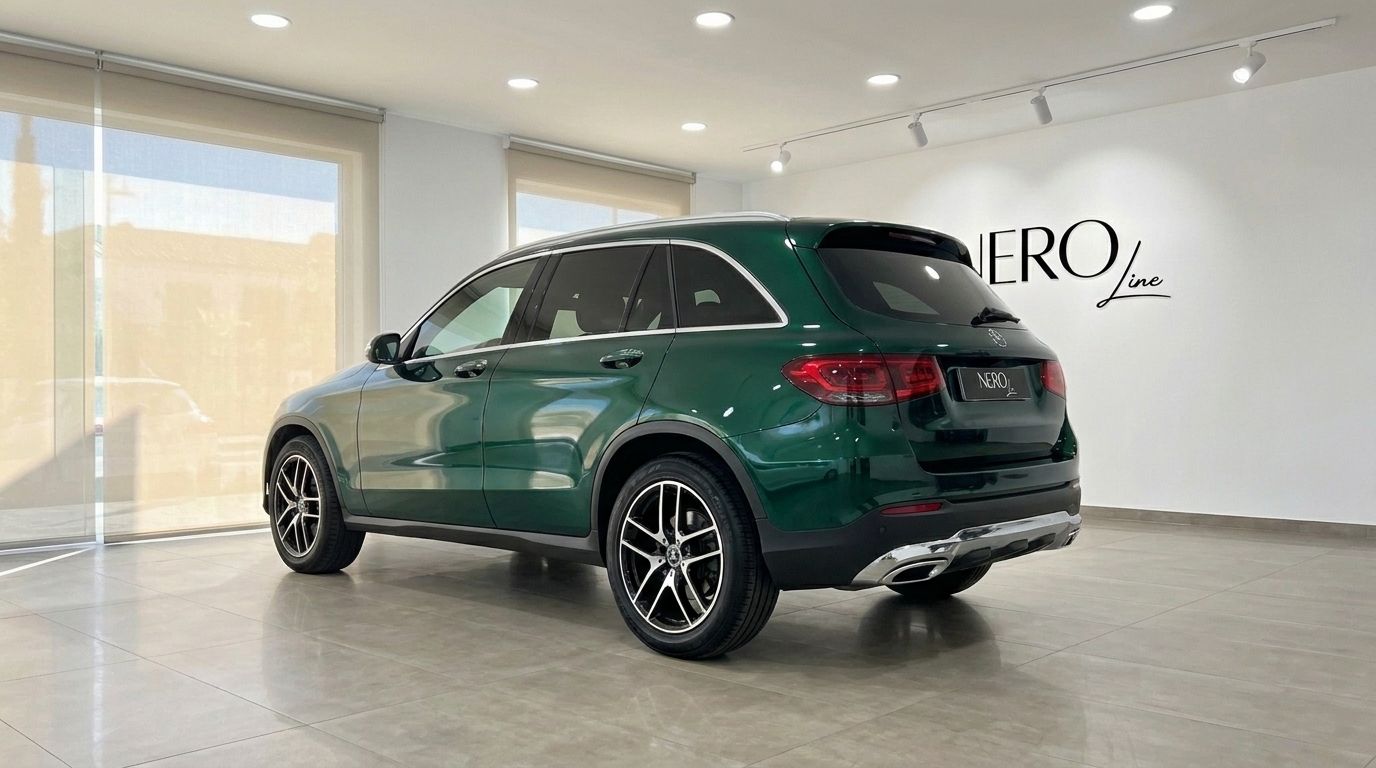 The Gloss Emerald Green Mercedes-Benz GLC 2021, viewed from the rear three-quarter angle, parked in a showroom in Mallorca.