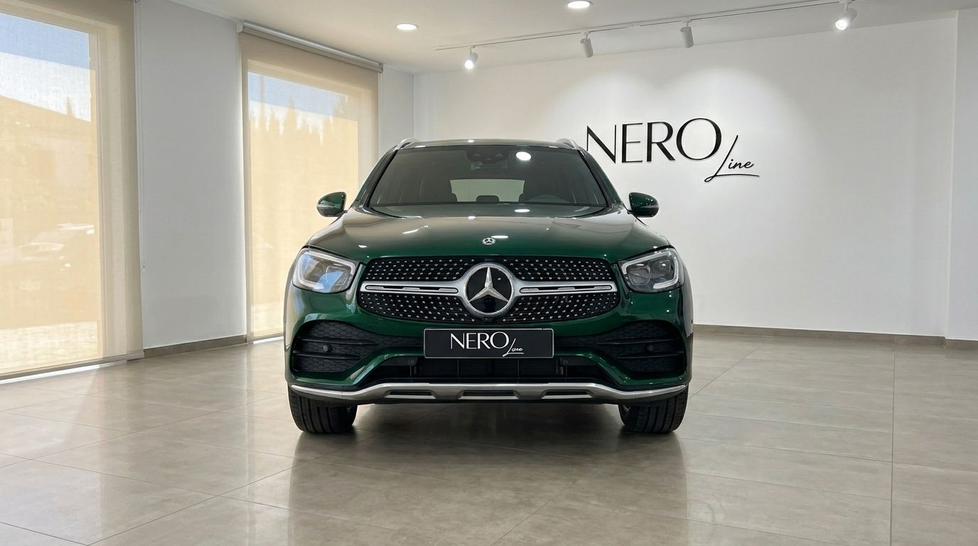 The glossy emerald green 2021 Mercedes-Benz GLC is showcased from the front view in a bright showroom in Mallorca.