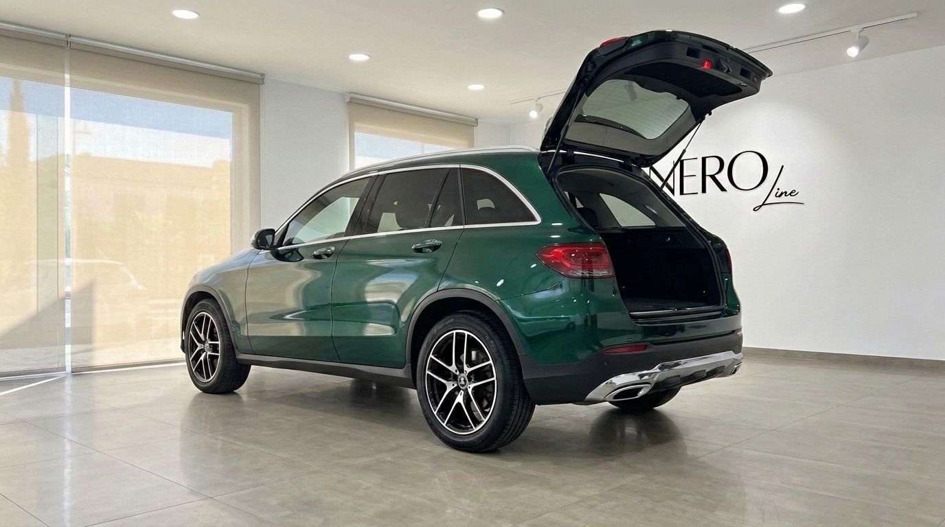 The 2021 Mercedes-Benz GLC in Gloss Emerald Green, viewed from the rear three-quarter with its trunk open, parked in Mallorca.