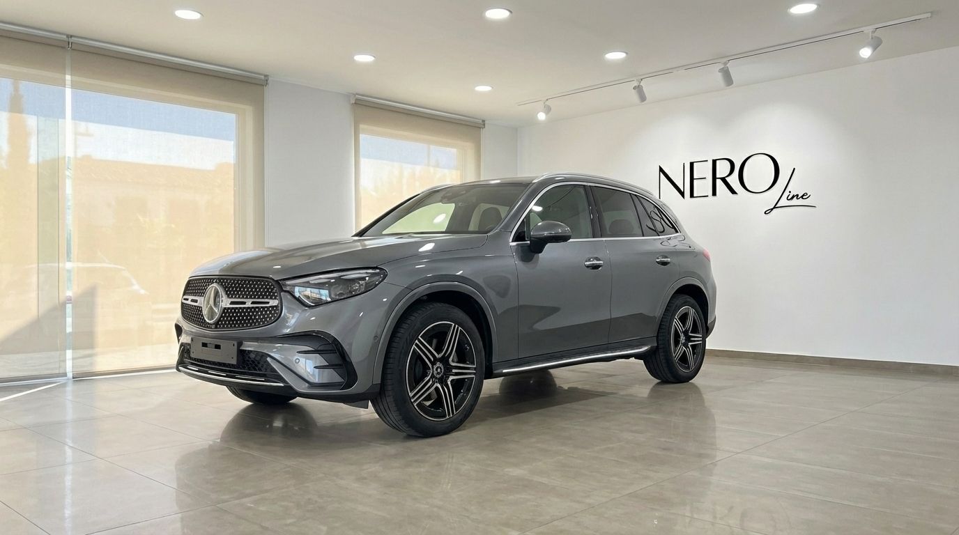 The metallic grey 2025 Mercedes-Benz GLC 200 SUV is showcased from a front three-quarter view in a showroom in Alicante.
