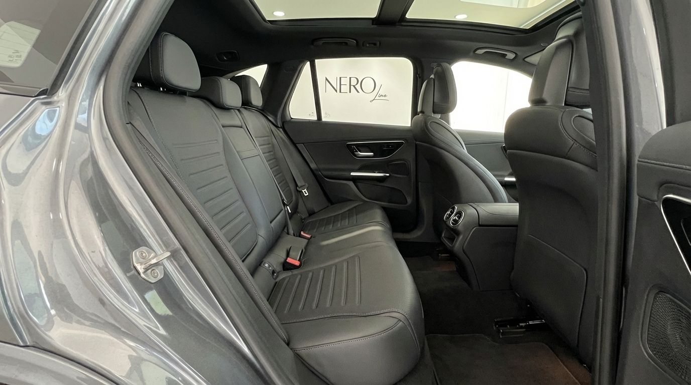 The luxurious rear passenger compartment of the Mercedes-Benz GLC 200 in Alicante, featuring black leather seats and a panoramic sunroof.