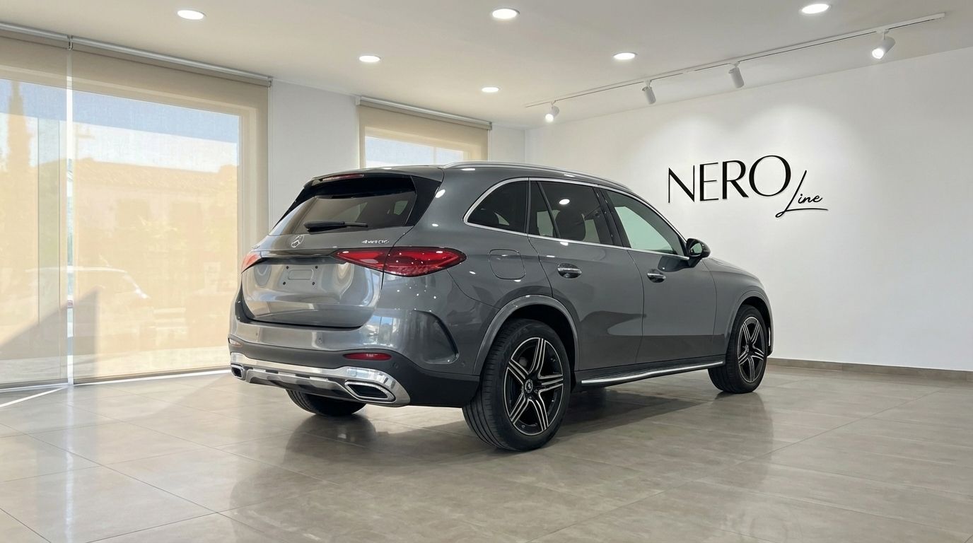 The metallic grey Mercedes-Benz GLC 200 is showcased from its rear three-quarter angle in a bright Alicante showroom.