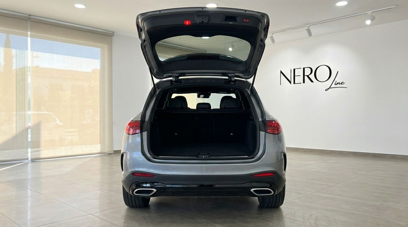 The rear view of the metallic grey 2025 Mercedes-Benz GLC 200 in Alicante, showcasing its spacious open trunk.