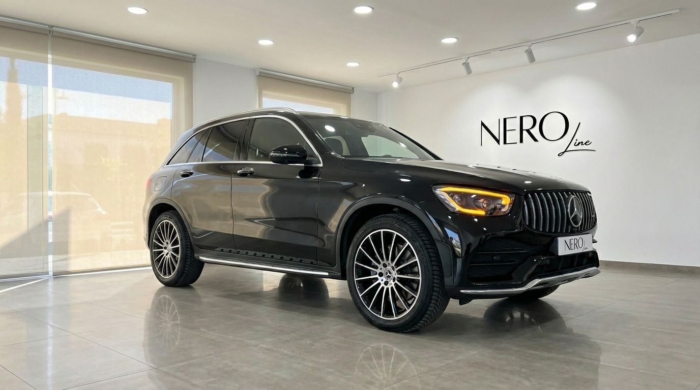 The black 2022 Mercedes-Benz GLC 300 AMG Line is showcased from a front three-quarter view in a showroom in Alicante.