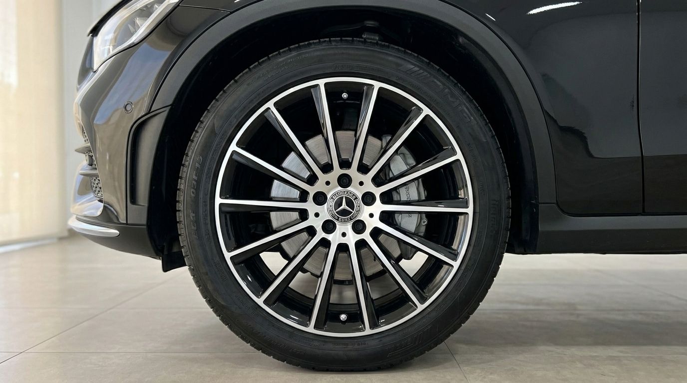 The front wheel and part of the black Mercedes-Benz GLC 300 AMG Line's bumper are visible, showcasing the multi-spoke alloy rim in Alicante.