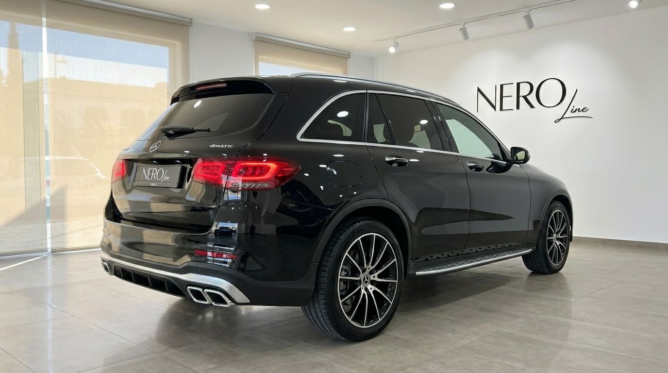 The black Mercedes-Benz GLC 300 AMG Line, a luxury performance SUV, is shown from the rear three-quarter angle in Alicante.