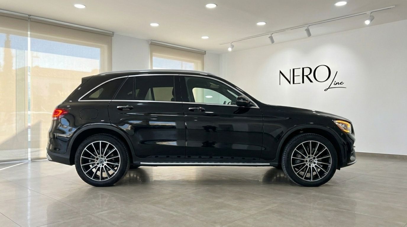 The black Mercedes-Benz GLC 300 AMG Line SUV is showcased in a showroom with the Nero Line logo in Alicante.