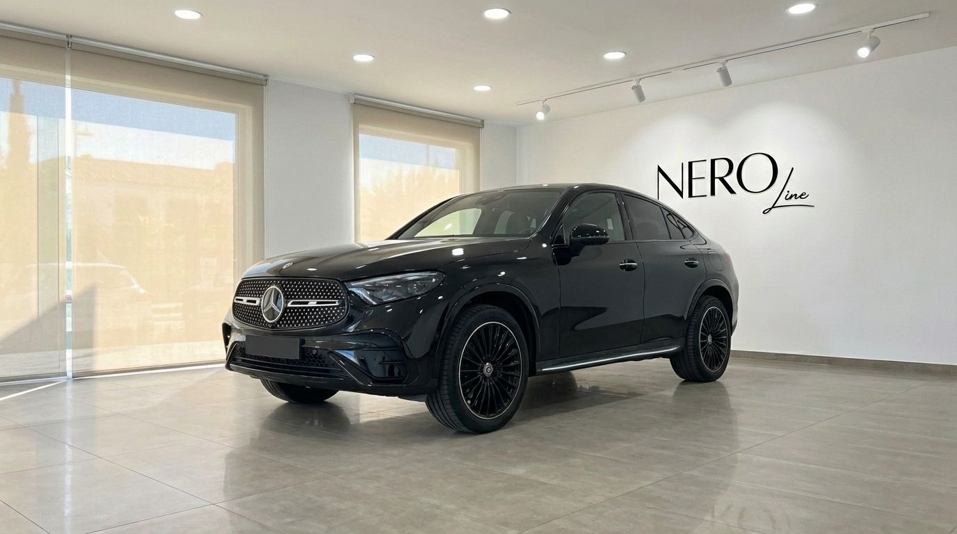 A metallic black 2025 Mercedes-Benz GLC 300d Coupe is prominently displayed in a bright showroom, shown from a front three-quarter view in Alicante.