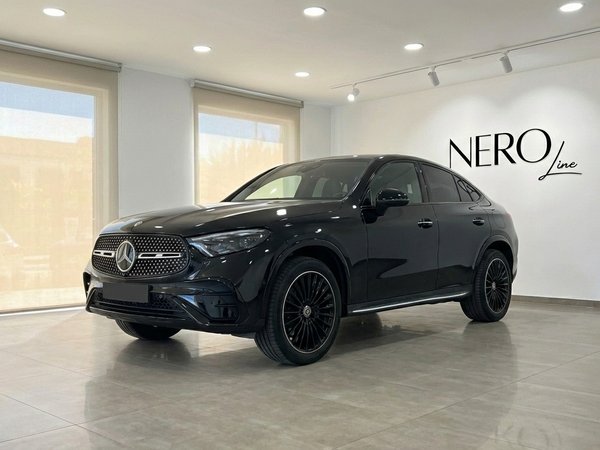 Mercedes-Benz GLC 300d Coupe — Luxury Rental A metallic black 2025 Mercedes-Benz GLC 300d Coupe is prominently displayed in a bright showroom, shown from a front three-quarter view in Alicante.