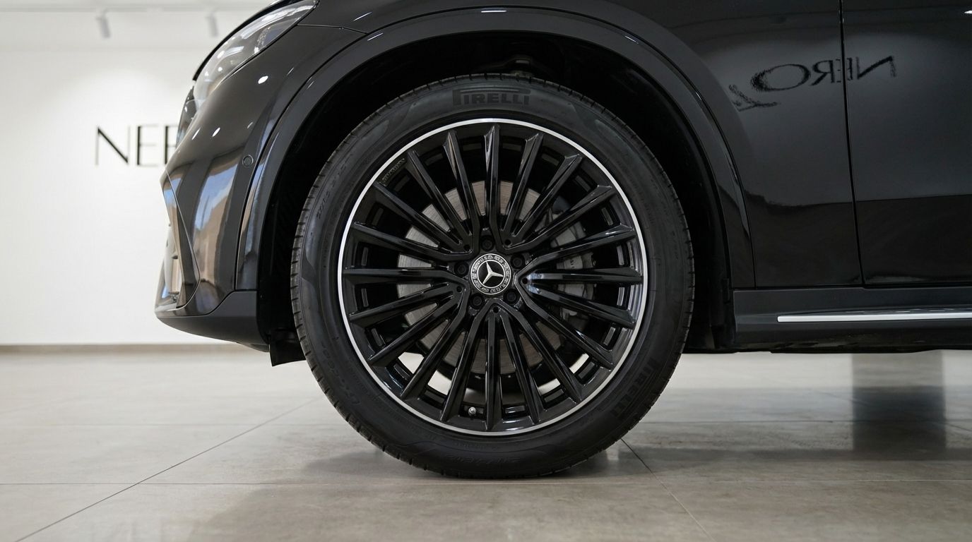 The metallic black Mercedes-Benz GLC 300d Coupe's front wheel and fender are prominently displayed in Alicante.