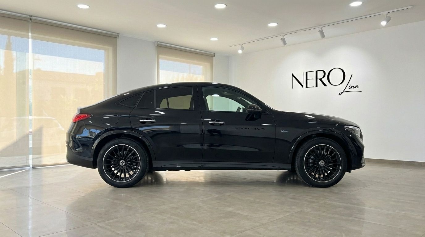 The metallic black 2025 Mercedes-Benz GLC 300d Coupe is showcased from its sleek side profile in a showroom in Alicante.