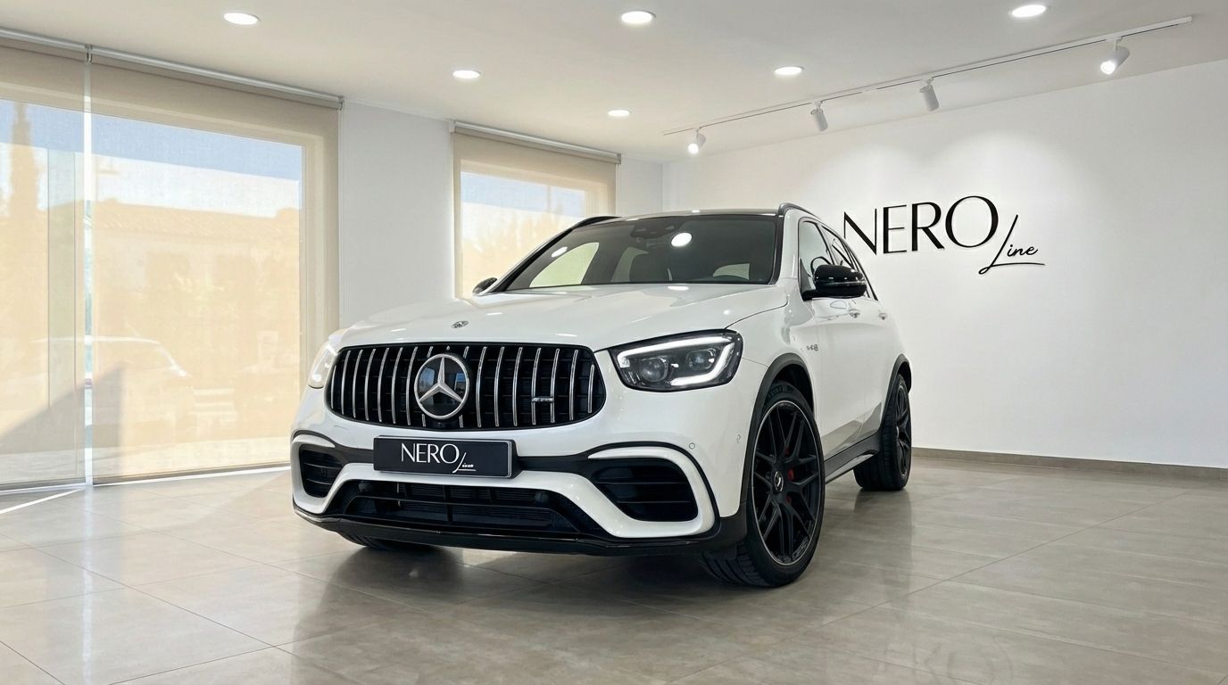 The white 2022 Mercedes-Benz GLC 63 S AMG is showcased from a front three-quarter view in a Marbella showroom.