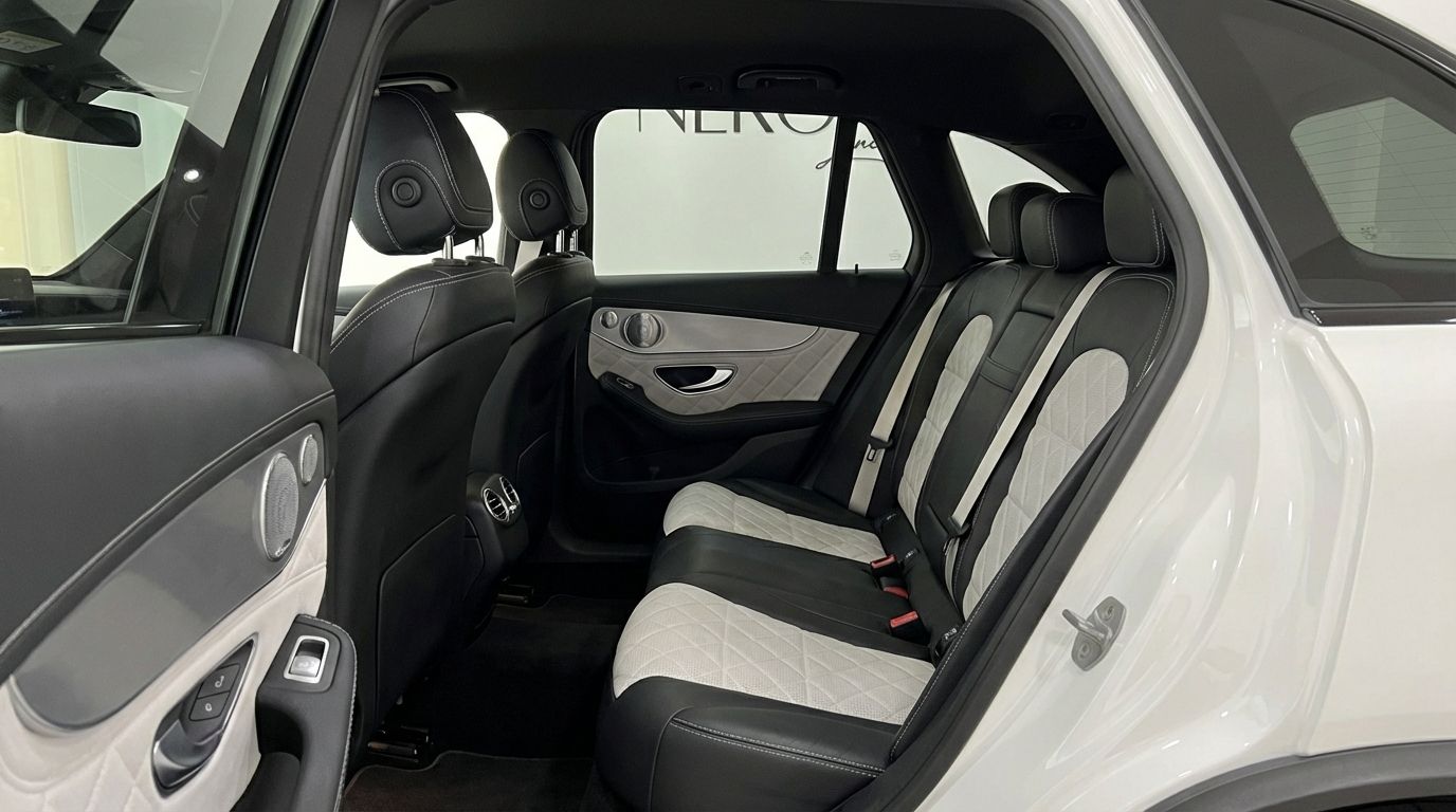 The Mercedes-Benz GLC 63 S AMG rear interior features black and white quilted leather seats and a detailed door panel in Marbella.