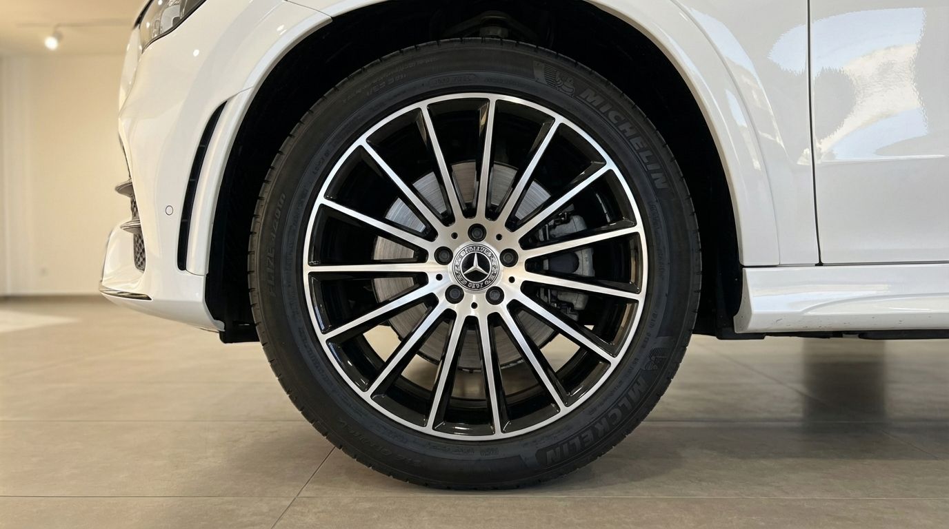 The front wheel and tire of the white Mercedes-Benz GLE 350e AMG, showcasing its multi-spoke alloy rim in Alicante.