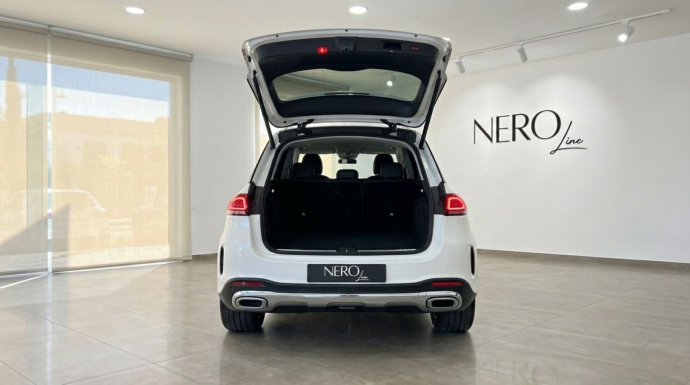 The white Mercedes-Benz GLE 350e AMG is shown from the rear with its trunk open, revealing the spacious cargo area in Alicante.