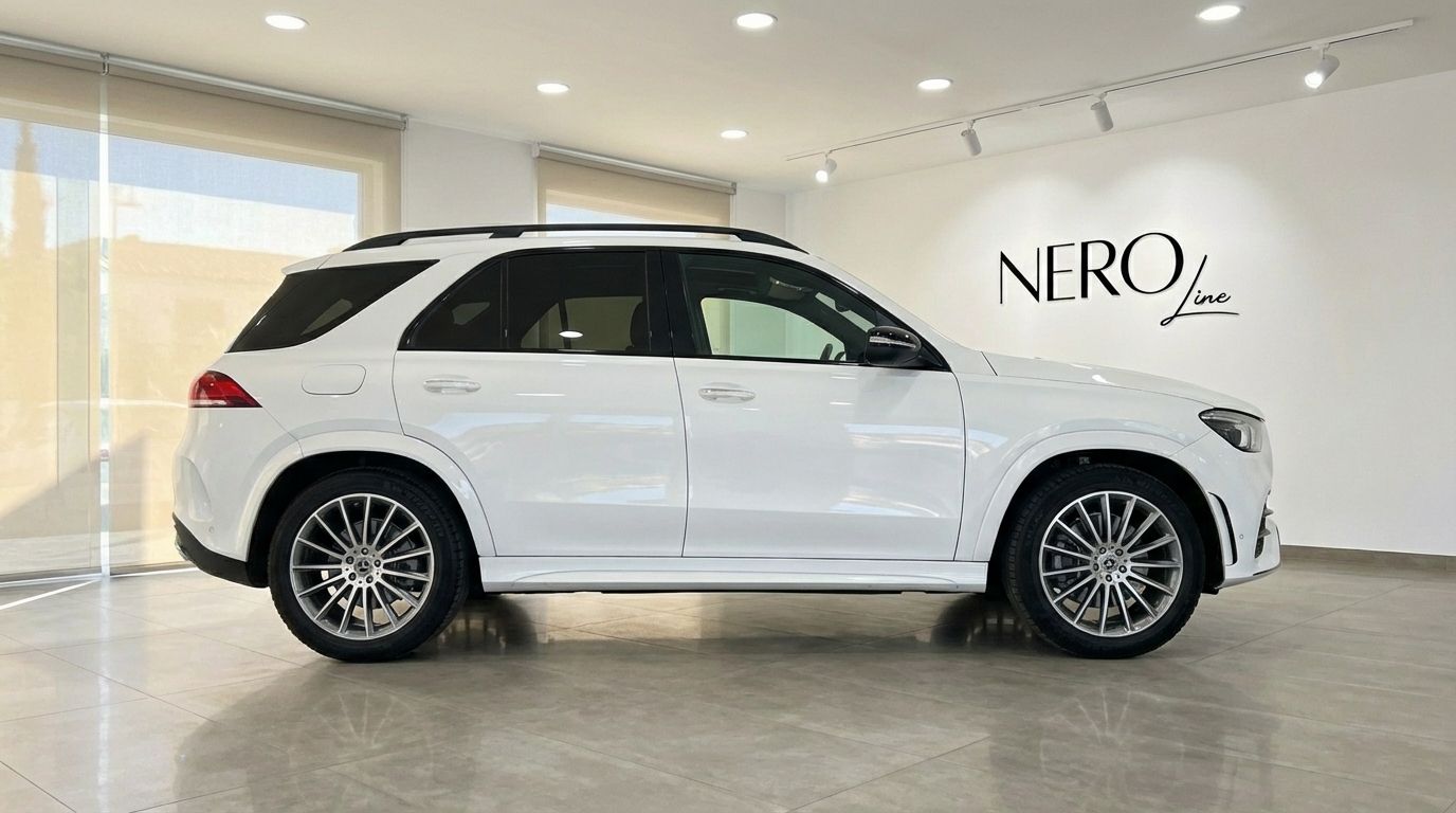 White Mercedes-Benz GLE 350e AMG performance SUV displayed in side profile view inside a showroom in Alicante.