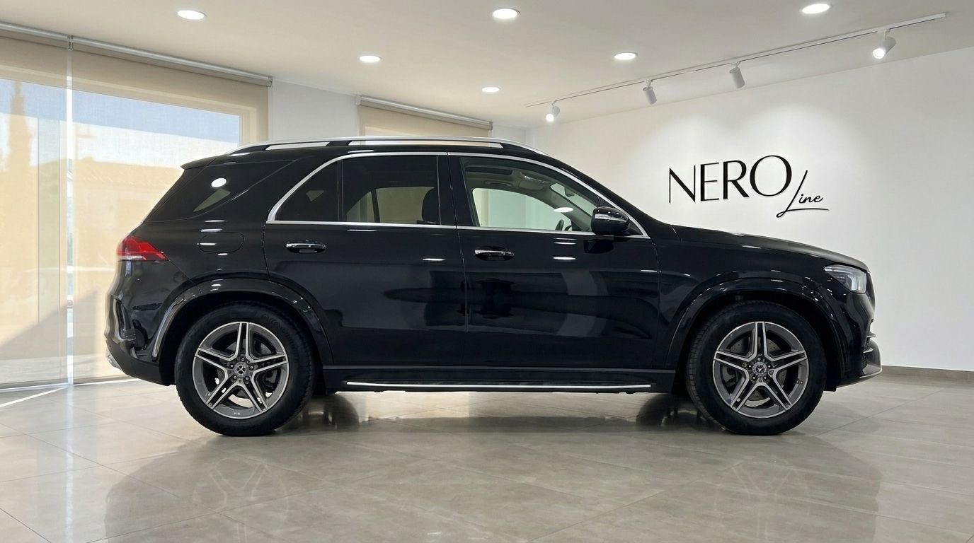 El Mercedes-Benz GLE 450 AMG 2021 negro brillante se muestra de perfil en un concesionario de Madrid.