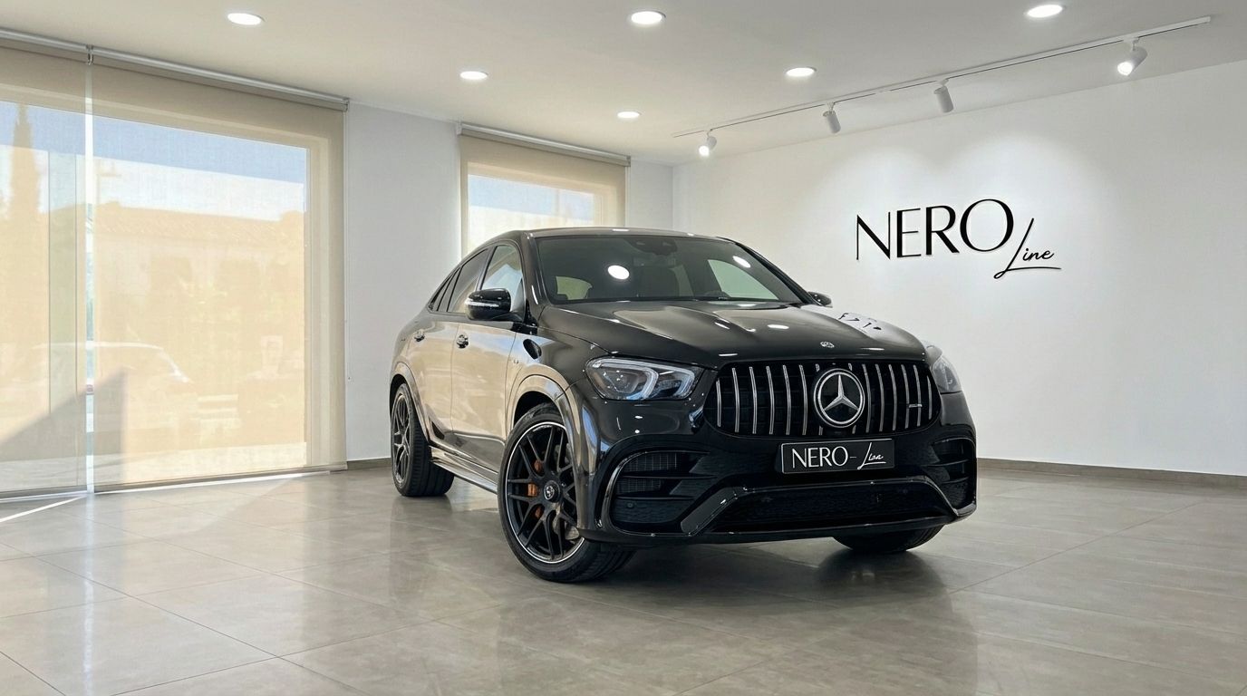 A glossy black Mercedes-Benz GLE 63s AMG performance SUV, viewed from the front three-quarter angle in a showroom in Alicante.
