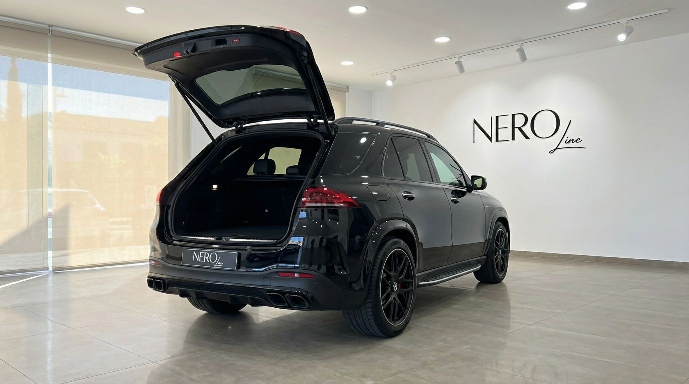 The glossy black 2022 Mercedes-Benz GLE 63s AMG SUV is shown from the rear with its trunk open in Alicante.