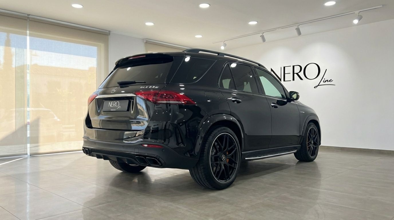 The glossy black Mercedes-Benz GLE 63s AMG, a performance SUV, is shown from its rear three-quarter angle in Alicante.