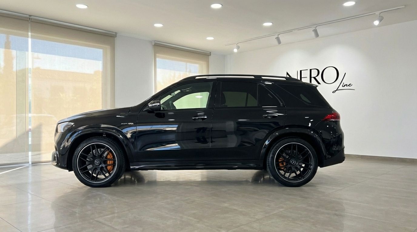 The glossy black Mercedes-Benz GLE 63s AMG SUV is shown from its side profile, parked indoors in Alicante.