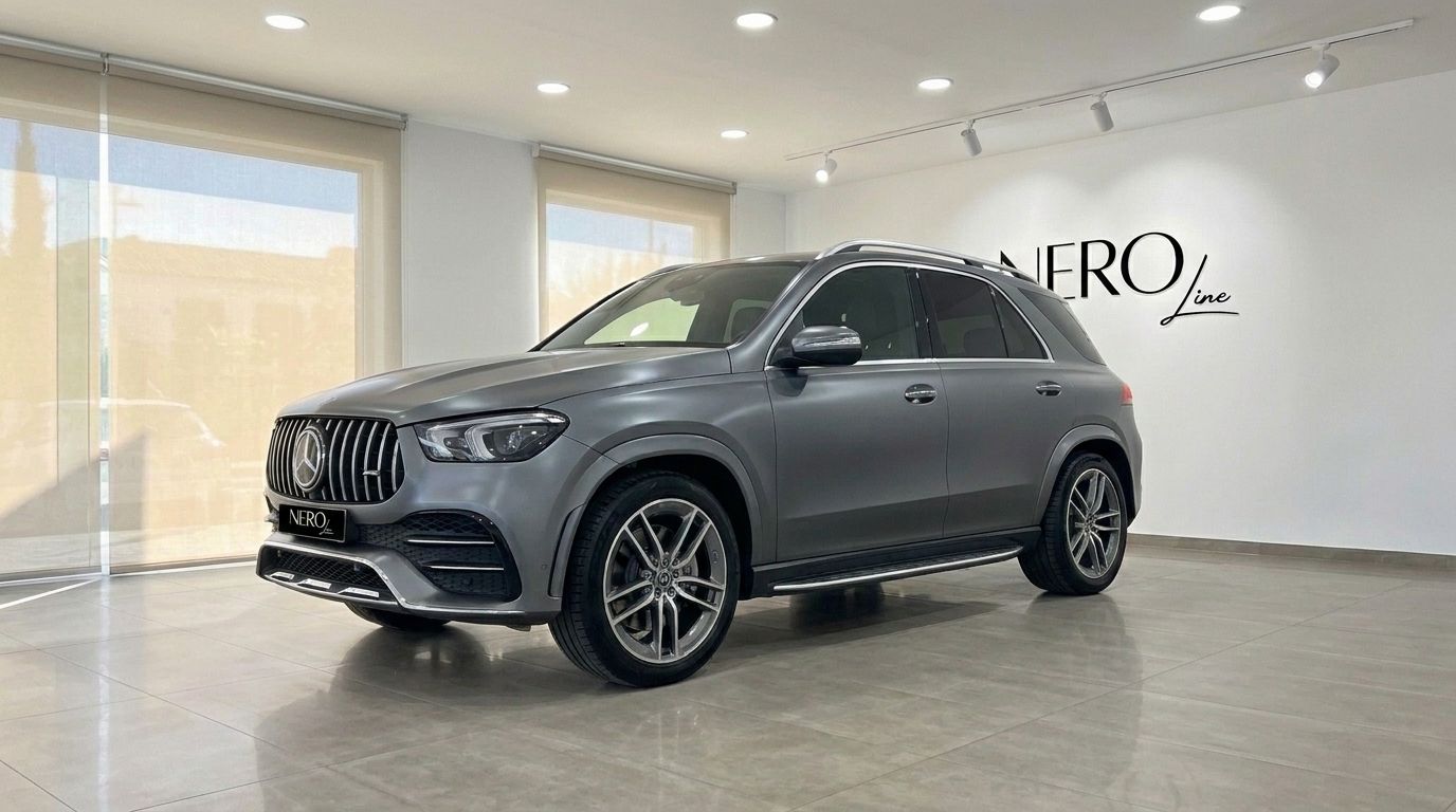 A matte Selenite Grey Magno Mercedes-Benz GLE AMG Line SUV is prominently displayed from a front three-quarter view in Mallorca.