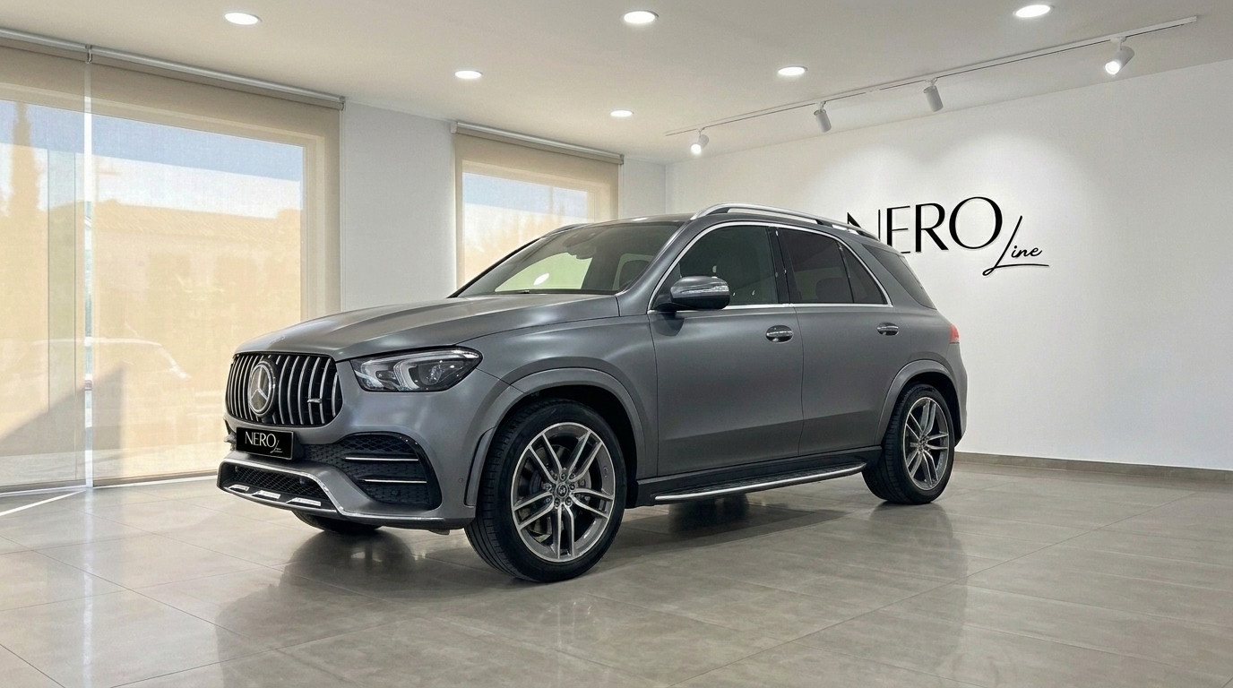 Mercedes-Benz GLE AMG Line — Front view Mallorca A matte Selenite Grey Magno Mercedes-Benz GLE AMG Line SUV is prominently displayed from a front three-quarter view in Mallorca.
