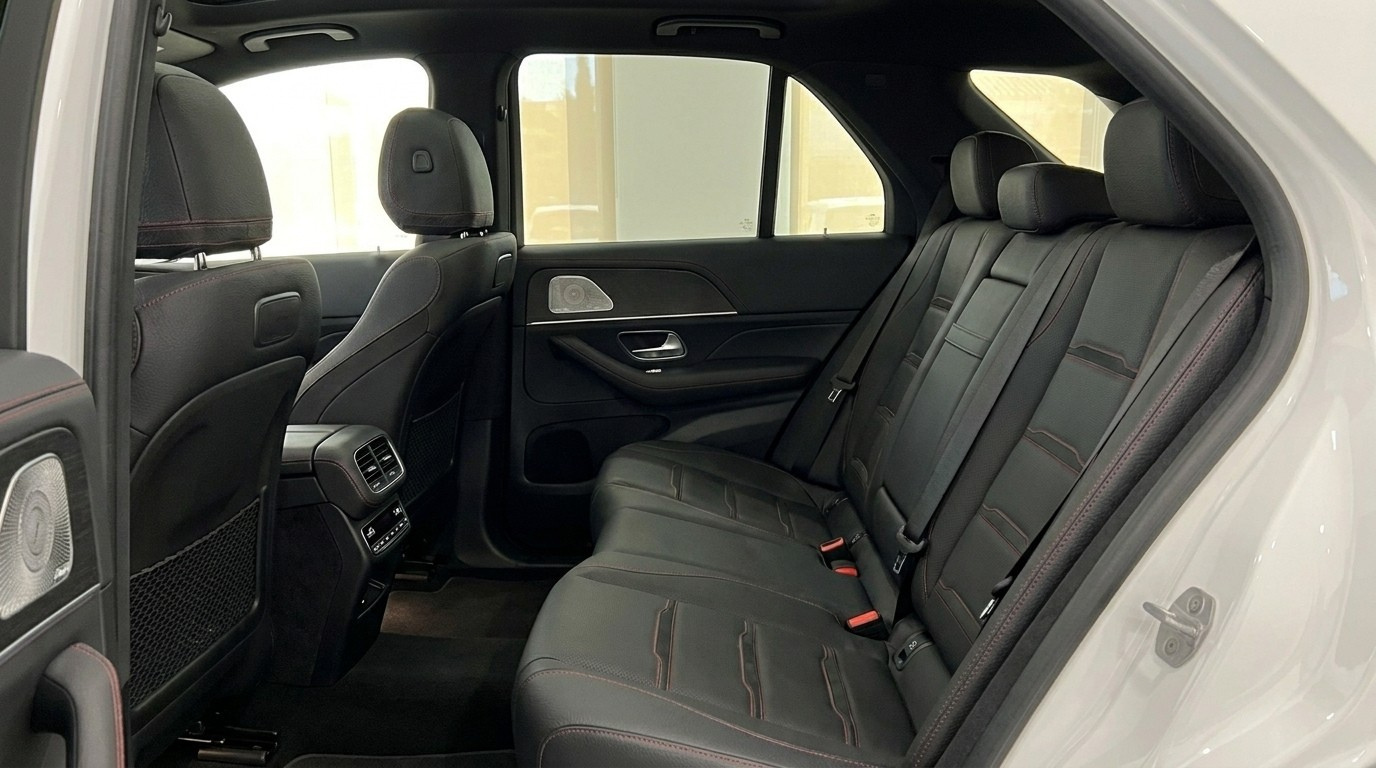 Mercedes-Benz GLE AMG Line's luxurious black leather rear seats and door panel with red stitching in Mallorca.